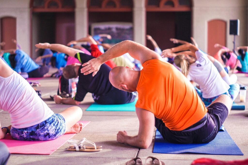 group of people sitting and doing yoga